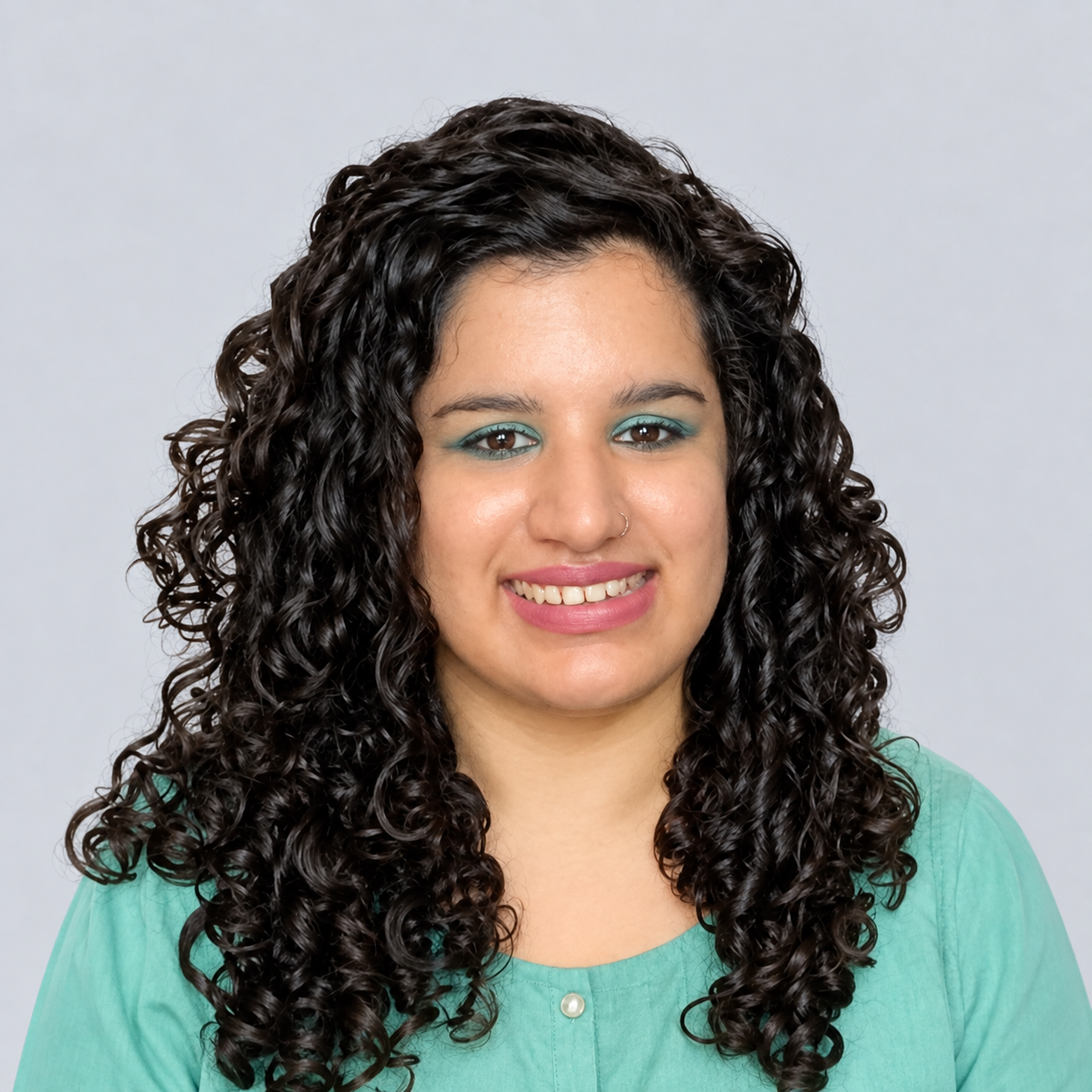 Warmly Smiling Curly-Haired Studio Portrait